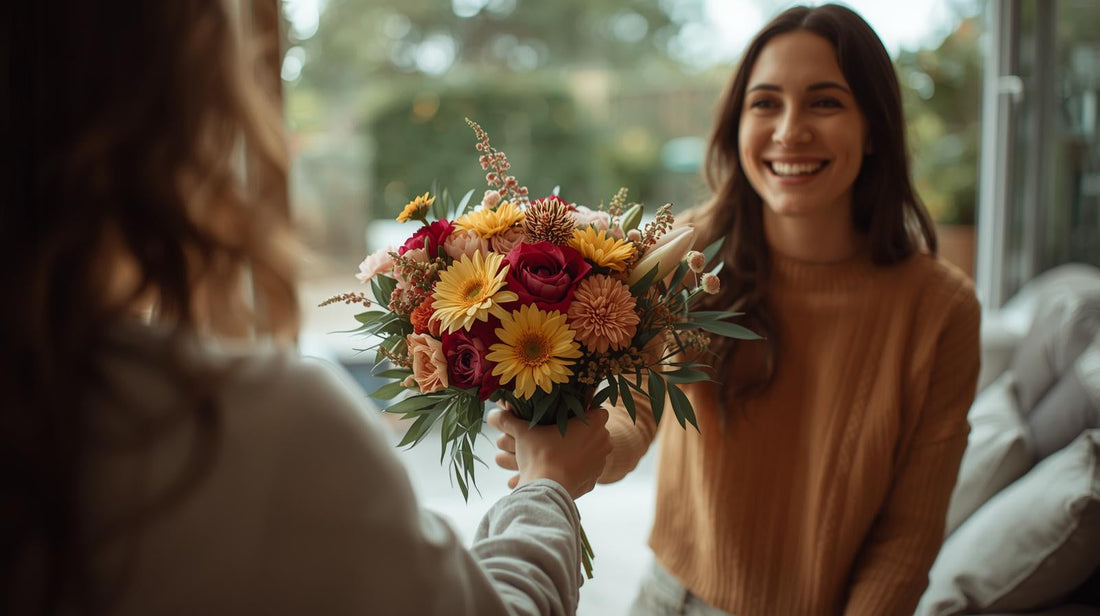 A person handing a fresh flower bouquet to another person as a thank-you gesture, showing appreciation and kindness